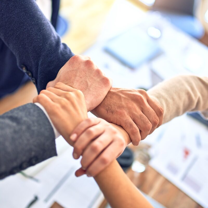 person in black long sleeve shirt holding persons hand